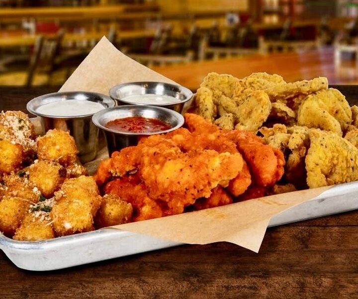 A sampler platter of wings, fried mozzarella and fried pickles at Twin Peaks Omaha
